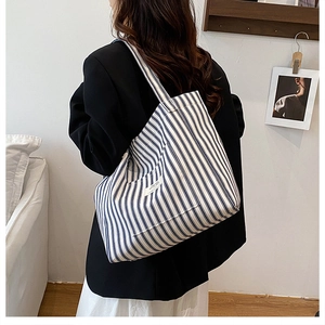 Detail of blue and white striped canvas tote bag showing large capacity for women