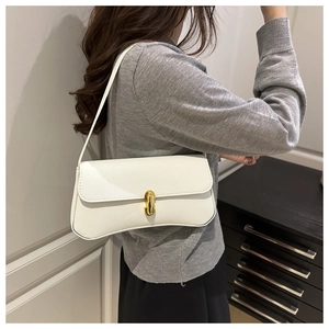 Detail shot of white lychee grain leather underarm bag with golden oval rotary lock