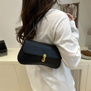 Minimalist black baguette shoulder bag with crocodile pattern and golden metal clasp buckle