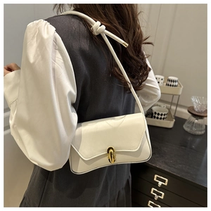 Détail du sac à bandoulière en cuir blanc avec sangle nouée et fermoir pivotant doré