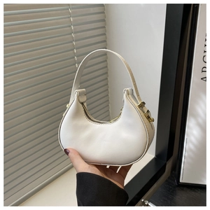 Detail of white crescent handbag with lychee texture leather and golden zipper hardware