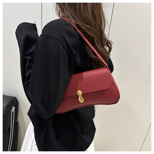 Side view of red lychee pattern underarm bag with gold U-shaped metal buckle on model
