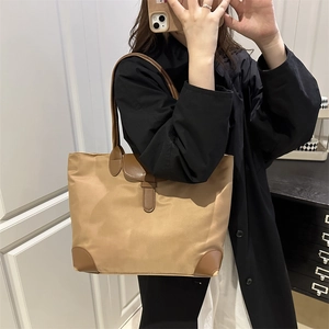 Khaki nylon tote bag with brown leather handles for casual style and large capacity