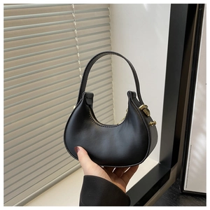 Detail view of small black crescent handbag with matte PU leather and gold hardware