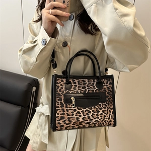 Trendy leopard print crossbody tote bag with black handles and adjustable shoulder strap