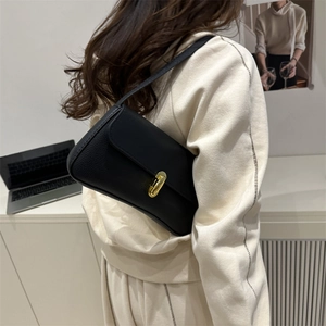Chic black lychee grain leather underarm bag with gold twist lock for elegant women