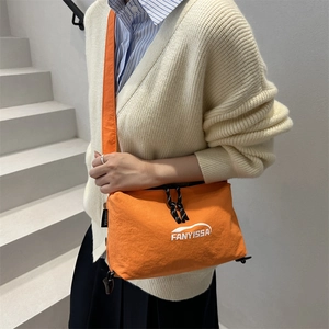 FANYISSA orange nylon crossbody bag with logo for women on casual indoor model