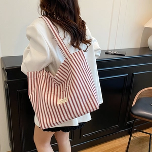Striped canvas tote bag for women featuring red and white vertical patterns in a casual style