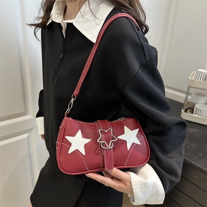 Red pebbled leather underarm bag featuring white star patches and silver star metal buckle