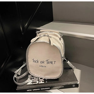 Detail of a white Halloween backpack featuring 'Toick or Traet' text and silver metallic trim