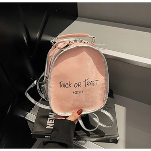 Detail of pink PU leather backpack with silver trim and stylish handwritten text print