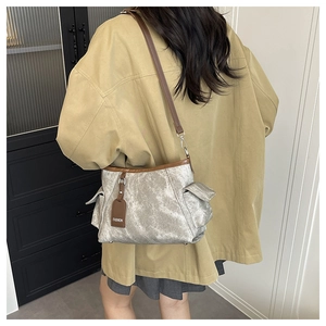Retro silver-grey crossbody bag with brown leather trim and fashion tag detail