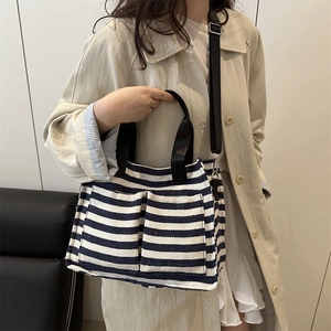 Blue and white striped canvas tote bag with adjustable shoulder strap and dual handles