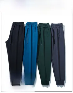 Macro detail of elastic drawstring waistbands and ribbed cuffs on multi-color jogger pants