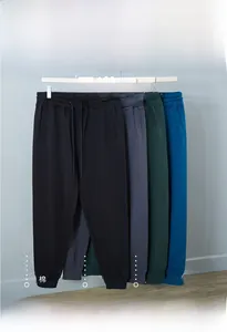 Close-up of premium cotton joggers showing 95.4% cotton fabric and available colors