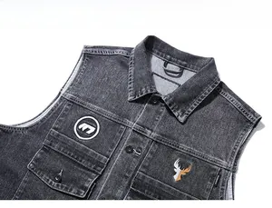 Detail view of dark grey denim vest showing intricate deer head and M letter embroidery