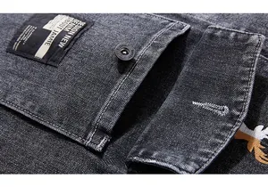 Macro detail of washed denim jacket featuring metal buttons and intricate eagle embroidery