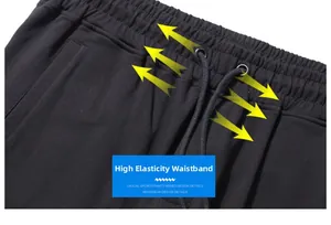 Detailed close-up of high elasticity waistband on black joggers with drawstring design