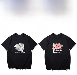 Detail view of black crew neck T-shirts with colorful cartoon tiger graphic prints