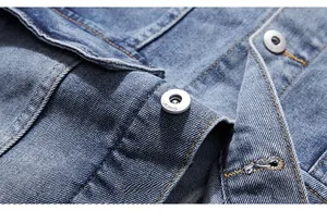 Macro shot of matte metal buttons and washed denim fabric on the casual jacket