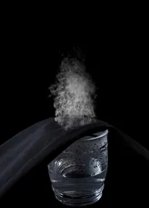 Macro shot of breathable black sports fabric showing steam ventilation for quick-dry comfort