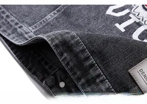 Detail of heavy washed denim vest with white terry embroidery and leather brand patch