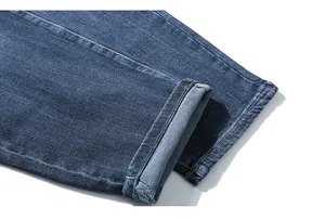 Detail shot of heavy dark blue denim jeans cuff showing inner stitching and texture