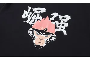 Detailed macro shot of cotton T-shirt featuring a pink Monkey King and calligraphy print