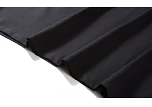 Detail of the high-quality double-needle stitching on the black cotton T-shirt hemline