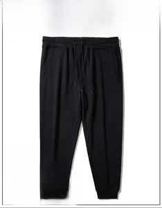 Detail of men's black sweatpants showing elastic drawstring waist and side pockets