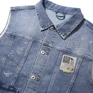 Light blue wash denim vest with detailed embroidery and patches for a trendy autumn look