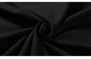 Close-up of premium black knitted fabric texture showing fine weave and soft material
