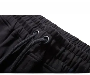 Detailed macro view of black elastic waistband with metal eyelets and matching drawstring