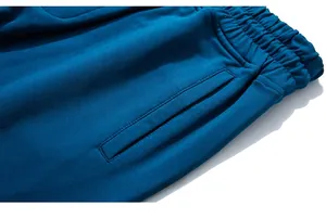 Detail of elastic waistband and side pocket on dark blue cotton blend sweatpants