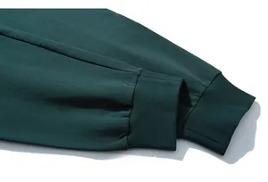 Close-up of forest green knitted rib cuffs with high-density cotton fabric texture