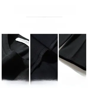 Detail view of round neckline, reinforced stitching and folded cuff on black long sleeve tee