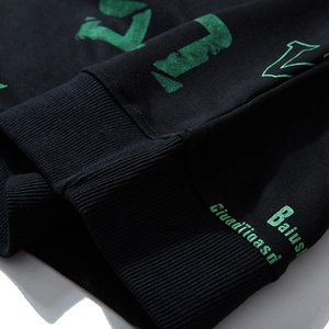 Oversized black sweatshirt featuring green letter print and ribbed cuffs for men