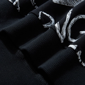 Oversized black sweatshirt featuring graffiti letter print and ribbed knit texture details