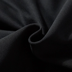Black oversized men's hoodie featuring textured knit fabric and reflective laser print