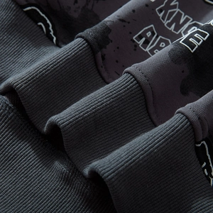 Dark gray oversized hoodie featuring camouflage bear print and ribbed cuff detail
