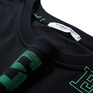 Oversized black crewneck sweatshirt with green letter print and textured cotton fabric