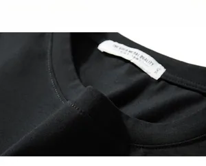 Close-up of the black cotton T-shirt neckline showing the 3XL woven label and fabric texture