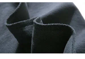 Detailed close-up of premium dark grey high-density knit fabric and stitching craftsmanship
