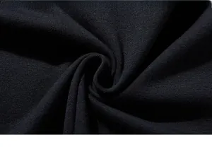 Macro shot of premium high-density black knitted cotton fabric showing texture and softness