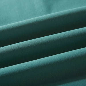 Close-up texture of a loose-fitting men's hoodie in deep teal knitted fabric