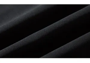 Macro detail of high-density black knitted cotton fabric texture and thickness