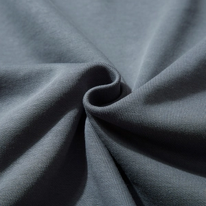 Close-up texture of soft dark grey knit fabric for men's oversized loose sweatshirt