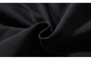 Macro detail of high-quality black knit fabric showing premium texture and fiber density