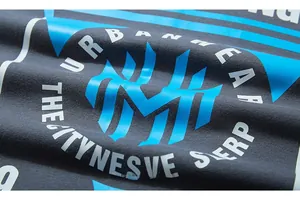 Macro shot of dark grey cotton fabric with blue urbanwear graphic print and textures