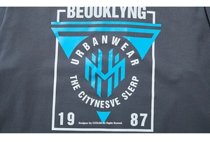 Detailed view of the screen-printed urban graphic and fabric texture on a charcoal gray tee